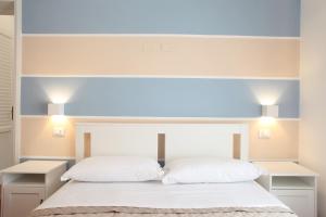 a bedroom with a bed with two white pillows at Country Villa San Vito Bay in San Vito lo Capo