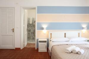 a bedroom with two beds with towels on them at Country Villa San Vito Bay in San Vito lo Capo
