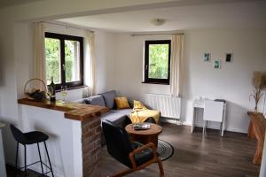 a living room with a couch and a table at House Narta - Rastoke in Slunj