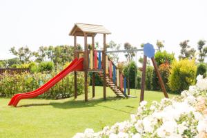 a playground with a slide in a park at Casa Vacanza Il Malandrone in Vada