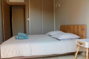 a bedroom with a large white bed with two pillows at L'ete Indien 2 in Sanary-sur-Mer