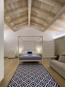 a bedroom with a bed and a couch at Relais Gregorio in Paternopoli