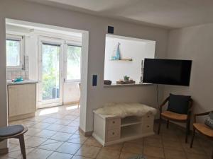 a living room with a flat screen tv on a wall at Casa Sibylle studio - piccolo paradiso in Minusio