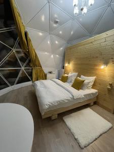 a bedroom with a bed in a room with a ceiling at Eco-turbaza Green Kolobok in Aktash