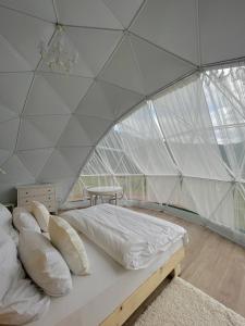 a bedroom with a bed in a tent at Eco-turbaza Green Kolobok in Aktash