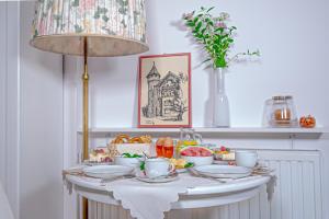 a table with plates and bowls of food on it at Piastowska in Polanica-Zdrój