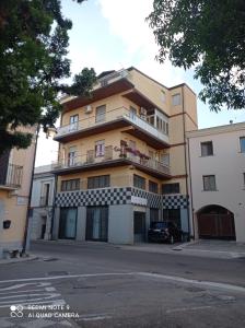 an apartment building with a car parked in front of it at B&B da Chiara in Tortolì