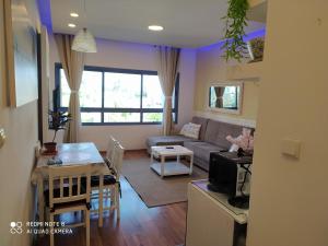 a living room with a couch and a table at Rotem Suite in MARINA ASHKLON in Ashkelon