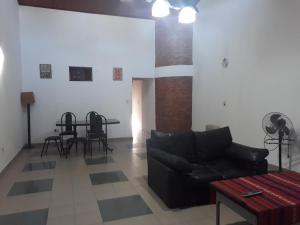 a living room with a couch and a table at Hermosa Casita II Paso Patria in Paso de la Patria