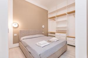 A bed or beds in a room at MagnoliaApartments - 18A Visconti Duomo