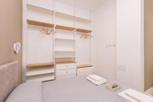 a small bedroom with a bed and a mirror at MagnoliaApartments - 18A Visconti Duomo in Milan