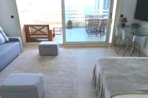 a living room with a bed and a couch and a table at Studio climatisé - belle vue mer-piscine in Beausoleil +4 photos