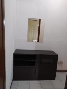 a bathroom with a black dresser and a mirror at Dony's holiday homes CISE 14923 