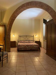 A bed or beds in a room at Affittacamere La Torre di Montalcino