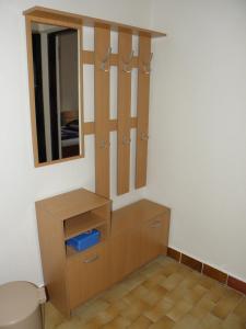 a bathroom with a wooden dresser and a mirror at Apartments Babić in Novalja