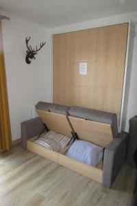 a bed in a room with a deer head on the wall at Superbe studio Les Angles in Les Angles