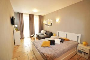 a bedroom with a bed and a couch in it at Kaliakria Sea View Apartments in Topola +70 photos