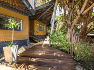 a wooden walkway in front of a yellow house at Saltwater Unit 4 in Point Lookout