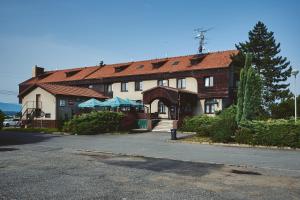 a large white building with a red roof at Motel Tošanovice in Dolní Tošanovice