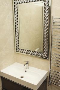 a bathroom with a sink and a mirror at Heart of Vilnius Apartment in Vilnius