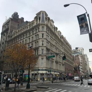 a large building on the corner of a city street at Studios in New York in New York