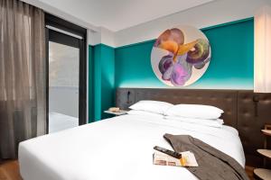 a bedroom with a white bed and a blue wall at Hyatt Centric Midtown 5th Avenue New York in New York