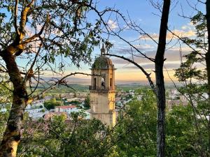 a tall building with a clock tower in a city at Casa Rural Osante in Labastida