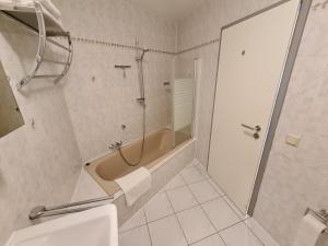 a bathroom with a shower and a tub and a sink at Große Ferienwohnung Nähe Flughafen Köln Bonn in Troisdorf +22 photos