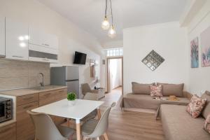 a kitchen and living room with a white table and chairs at Stavroula's Paradise House in Sikia