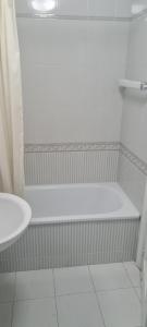 a white bathroom with a tub and a sink at La casa de la abuela in Narón +20 photos