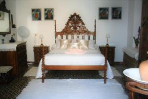 a bedroom with a large bed with a wooden headboard at 25 de Abril in Santa Cruz de la Sierra