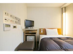 a hotel room with two beds and a television at R&B Hotel Umeda East - Vacation STAY 40693v in Osaka