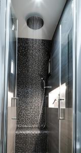 a bathroom with a shower and a staircase with a glass door at Terra Mia Savoia B&B in Naples