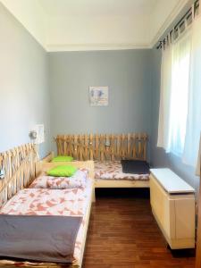 a bedroom with two beds and a desk in it at Pihi-Lak Apartman Siófok in Siófok