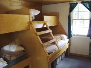 a room with two bunk beds and a window at HI Mosquito Creek - Hostel in Lake Louise