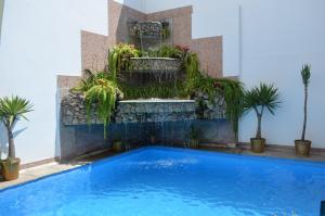a swimming pool with a large blue tub next to it at Miraflores Colon Hotel in Lima