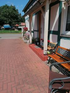 a bench sitting outside of a house with flowers at Ferienwohnung,Haus Elisa 2 in Stendal