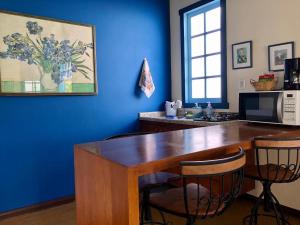 a kitchen with a wooden table and two chairs at CHALÉS DE SÃO JoSÉ in Tiradentes