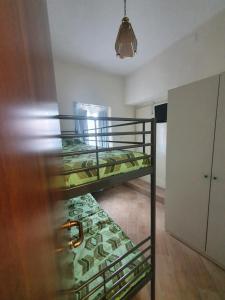 two bunk beds in a room with a door at B&B Castrum in Santo Padre