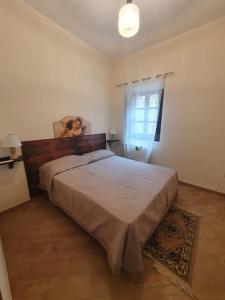 a woman is standing in a bedroom with a bed at B&B Castrum in Santo Padre