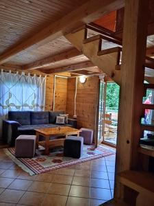 a living room with a couch and a table at Apartman Relax in Nature in Jajce