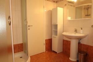 a bathroom with a sink and a shower and a toilet at Nikas1 Rabac in Rabac +22 photos