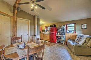 a living room with a table and a red refrigerator at Cozy Duck Lake Cabin Near Glacier Natl Park! in Saint Mary