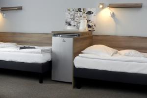 two beds sitting next to each other in a room at Hostel Helios in Września