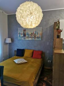 a bedroom with a bed with colorful pillows on it at Apartman Jovana 2 in Belgrade