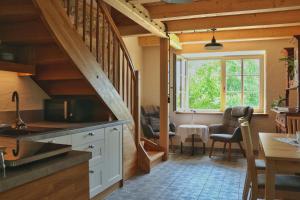 a kitchen with a staircase leading to a dining room at Little Vintage in Frankenberg