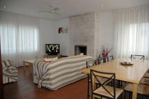 a living room with a couch and a table at Villa with pool, 200m from beach in Cala Blanca