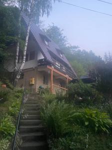 a house with stairs leading up to it at Małe Schronisko in Szczyrk