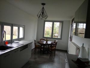 a kitchen with a table and a dining room at berdoulet in Bétracq