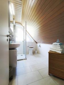 a bathroom with a sink and a toilet at Ferienwohnung Prange Cuxhaven in Cuxhaven